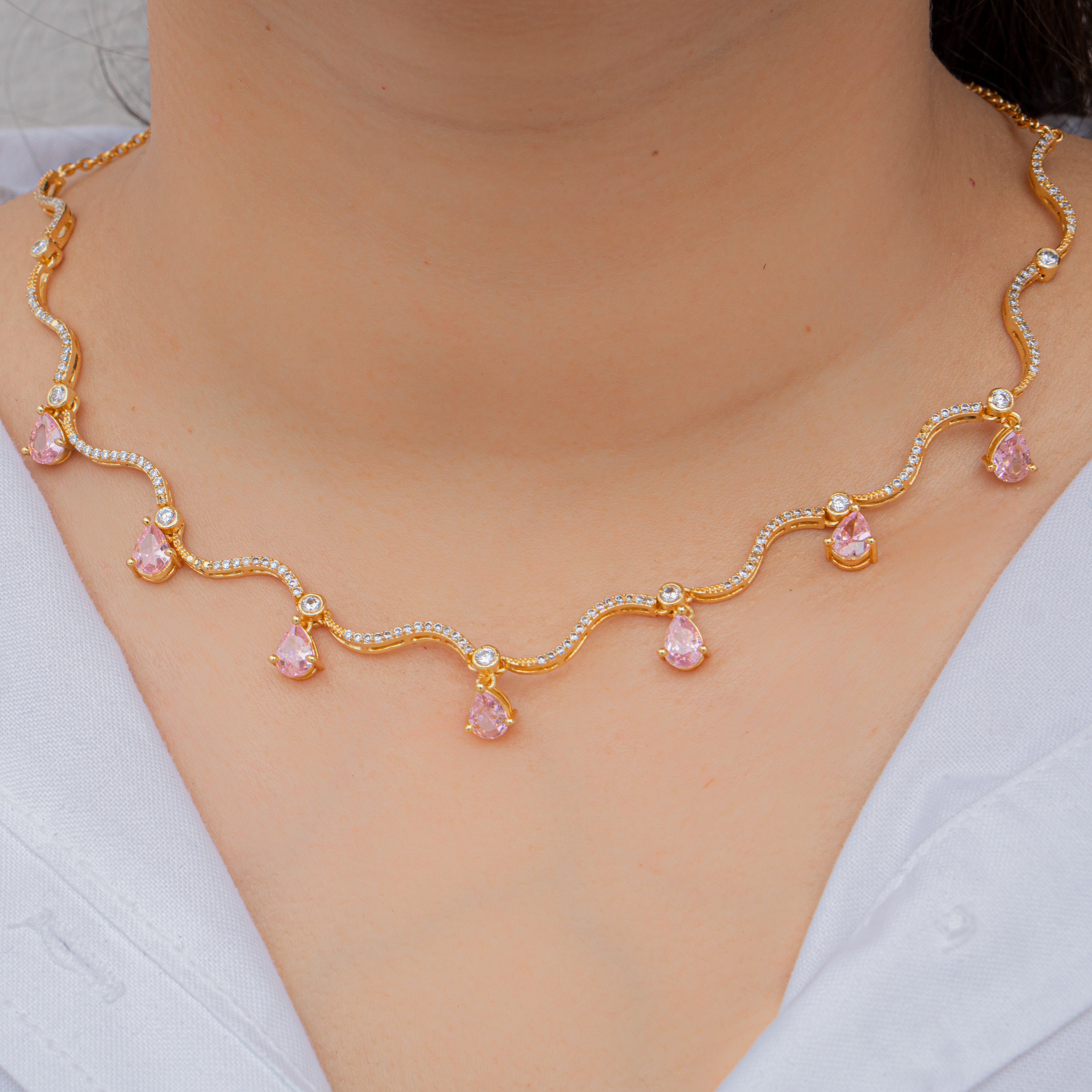 Wavy necklace with blush gems
